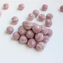 white on light pink polka dot swirl felt balls