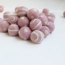 white on light pink polka dot swirl felt balls