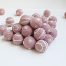 white on light pink polka dot swirl felt balls
